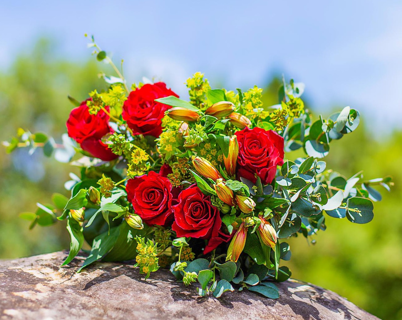 Fresh red rose bouquet with greenery